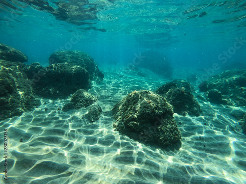 Diving in the sea water. Underwater walking at the bottom of the seash. photo