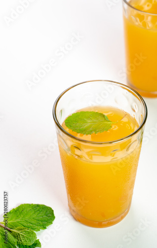 Delicious Orange and grapefruit juice in two glass with mint