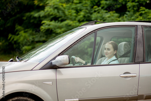 Pretty, young woman driving a car -Invitation to travel. Car rental or vacation © volody10