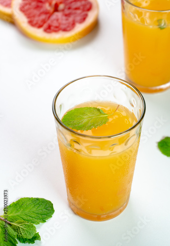 Fresh Orange and grapefruit juice in two glass with mint