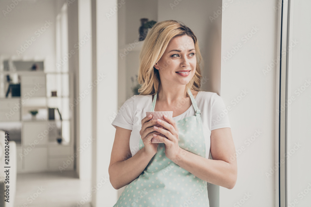 Portrait of her she nice attractive lovely cheerful cheery dreamy wavy-haired girl holding in hands cup cozy cosy comfort zone in light white interior kitchen studio indoors Portrait of her she nice attractive lovely cheerful cheery dreamy wavy-haired girl holding in hands cup cozy cosy comfort zone in light white interior kitchen studio indoors
