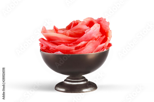 Pickled ginger in a metall bronze sauce-boat isolated on white background