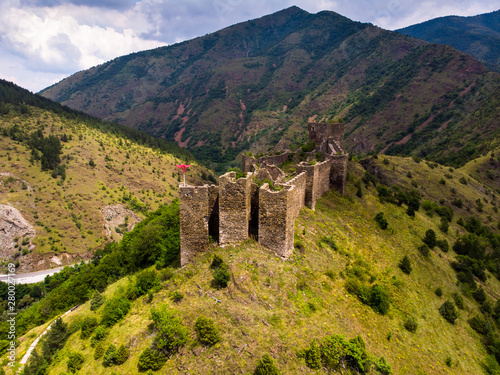 Ruins of medieval fortress Maglic on top of hill by the Ibar river in Serbia. Aerial view. Valley of this river is also called Lilac valley. photo