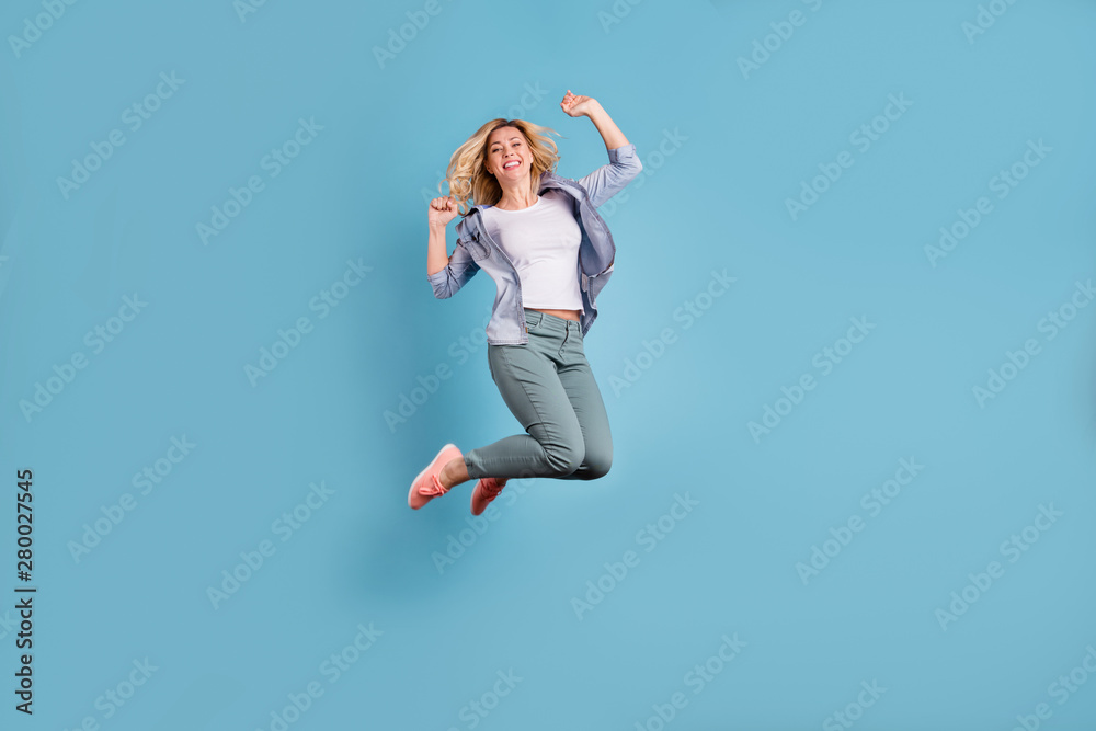 Full body photo of pretty lady raising arms wearing pants trousers isolated over blue background - obrazy, fototapety, plakaty 