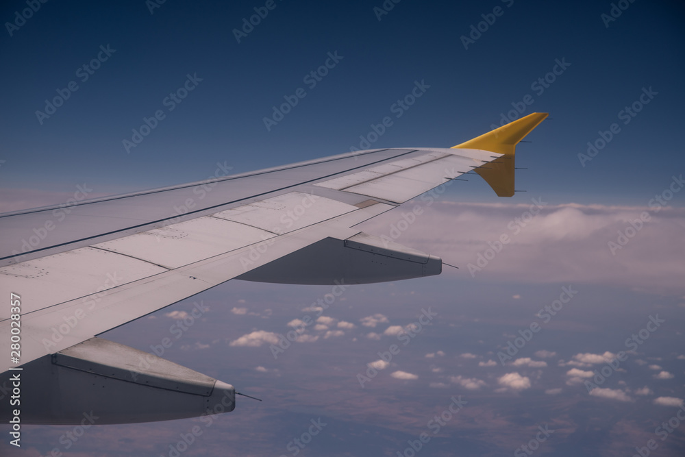 View from the window of a plane next to the wing. View from the window of a plane next to the wing.