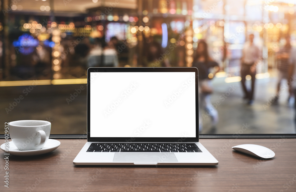 Laptop computer on wood table with mail connection message to mailing contacts phone, A global letters concept. in cafe restaurant with abstract bokeh light defocused background.