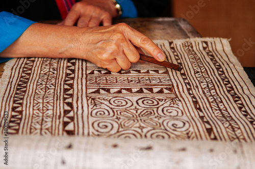 Laotian woman do Batik fabric painting