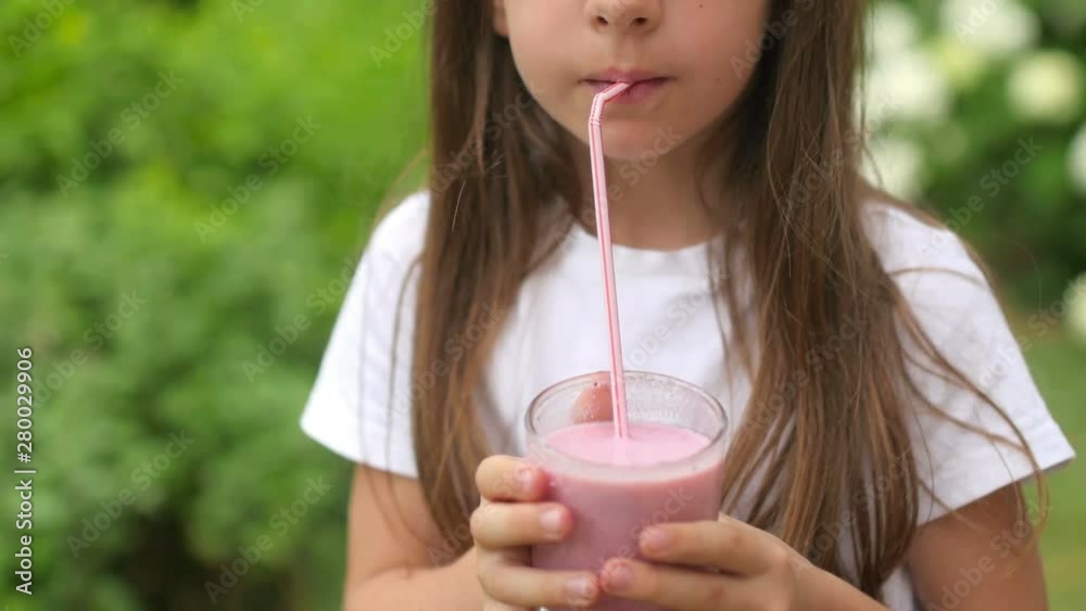 Healthy food, closeup little girl drinks fruit cocktail outdoors, organic food and drink concept. Healthy food, closeup little girl drinks fruit cocktail outdoors, organic food and drink concept.