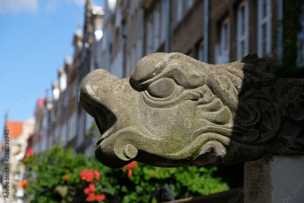 Gdansk Old Town, Poland - gargoyle. Very interesting architectonic detail. It is decorative, protruding top of the roof gutter, used to drain water beyond the reach of the wall. Gdansk Old Town, Poland - gargoyle. Very interesting architectonic detail. It is decorative, protruding top of the roof gutter, used to drain water beyond the reach of the wall.