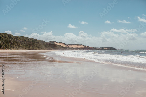 paradise beach without people with hills and palm trees