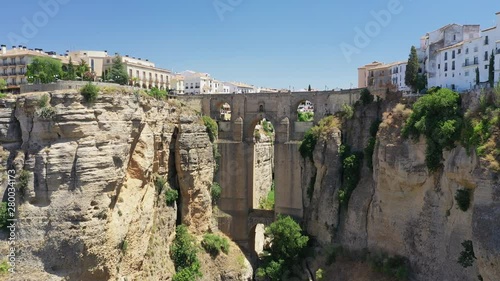 Aerial view of cityscape of Ronda, famous historic city with impressive arch bridge Puente Nuevo over gorge El Tajo - landscape panorama of Andalusia from above, province of Malaga, Spain, Europe