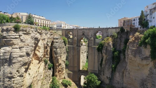 Aerial view of cityscape of Ronda, famous historic city with impressive arch bridge Puente Nuevo over gorge El Tajo - landscape panorama of Andalusia from above, province of Malaga, Spain, Europe