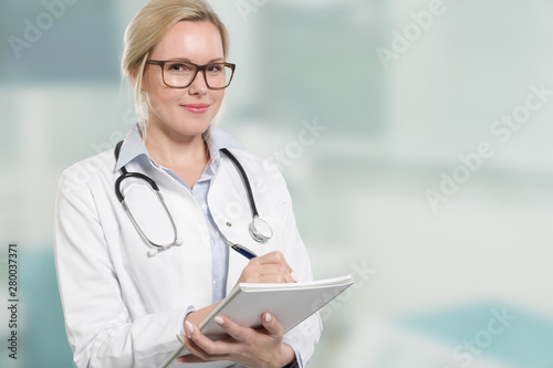 young female friendly doctor with stethoscope writes a prescription