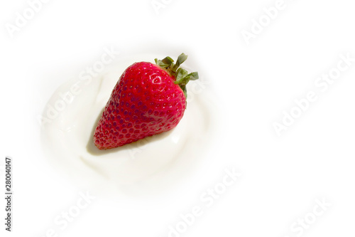 Yogurt with fresh strawberry on top on white background