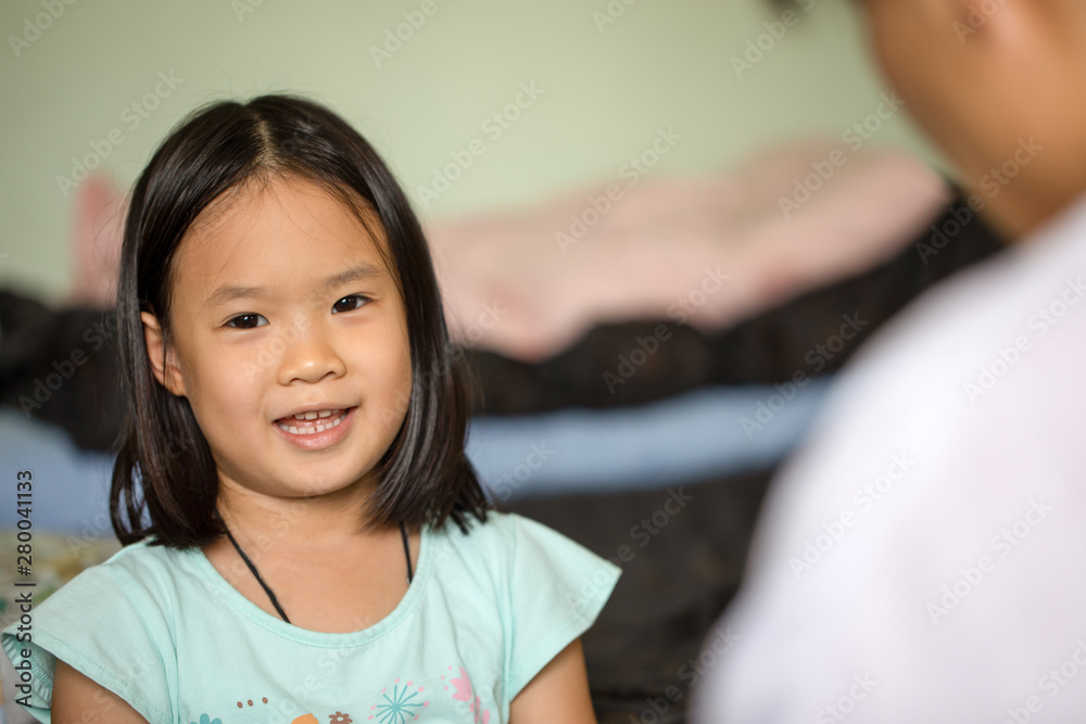 little Asian girl plays with mother with smile face little Asian girl plays with mother with smile face