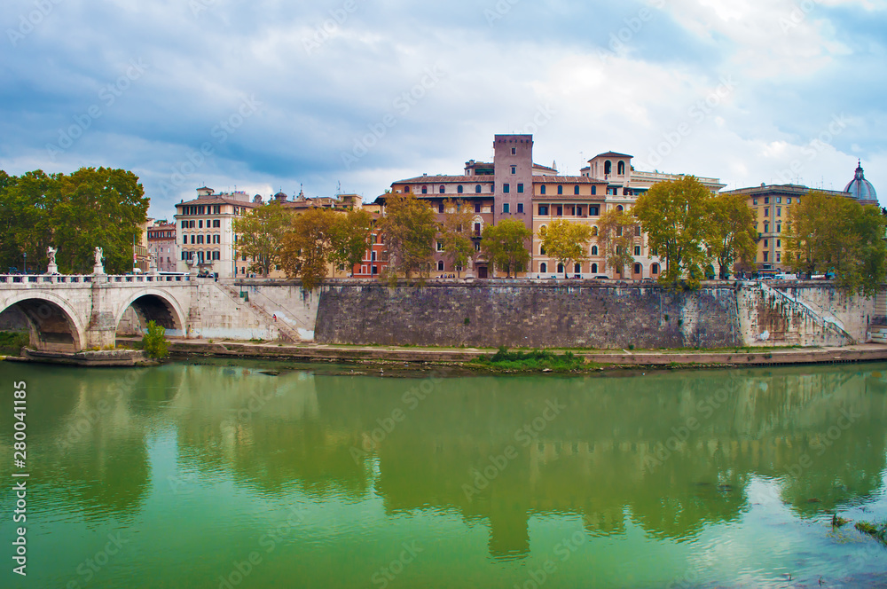 Fototapeta premium Several ancient stone buildings and ponte Sant'Angelo bridge