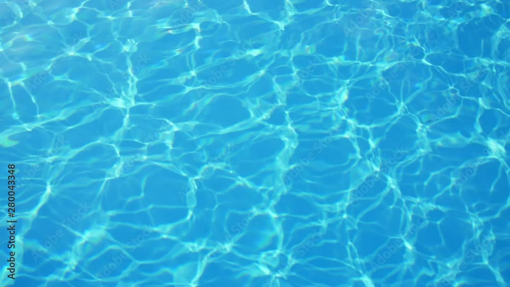 Beautiful turquoise swimming pool waters with shimmering sunny rays in slo-mo Beautiful turquoise swimming pool waters with shimmering sunny rays in slo-mo