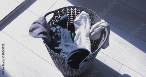 Dirty cloth falls to a laundry basket