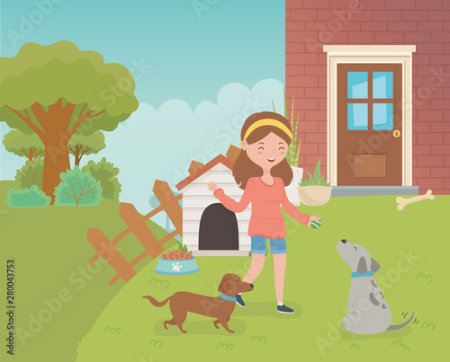 young woman with little dogs mascots in the house garden © Stockgiu