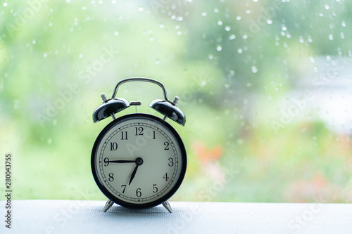 Vintage clock at the windows on raining day