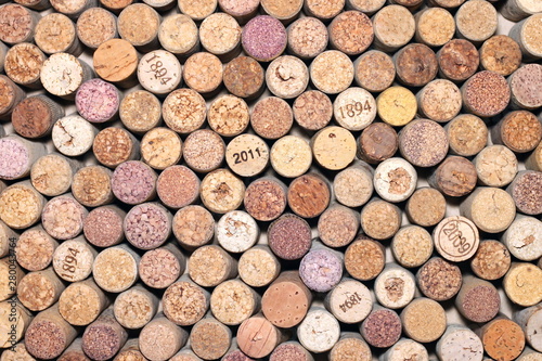 Abstract background of used red and white wine corks with corkscrew marks on corks and calendar dates on some corks