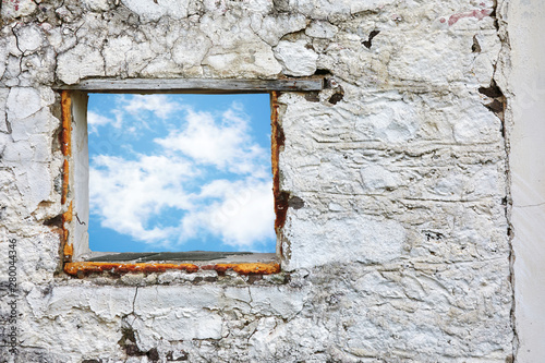 Canvas Print White old stone wall with blue sky and clouds window