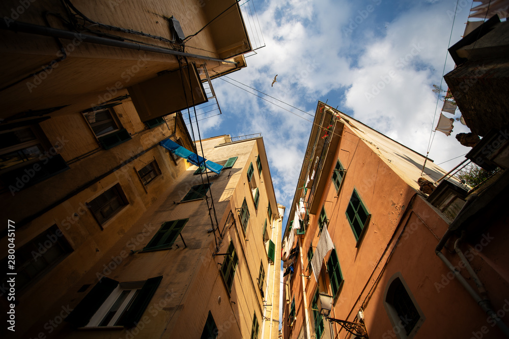 Narrow streets in Riomaggiore town at Cinque Terre, Italy in the summer Narrow streets in Riomaggiore town at Cinque Terre, Italy in the summer
