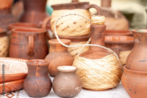 pottery. Pottery market in village Oposhnya, center of pottery production. Different pottery products: bowls, vases, jars on the market. photo