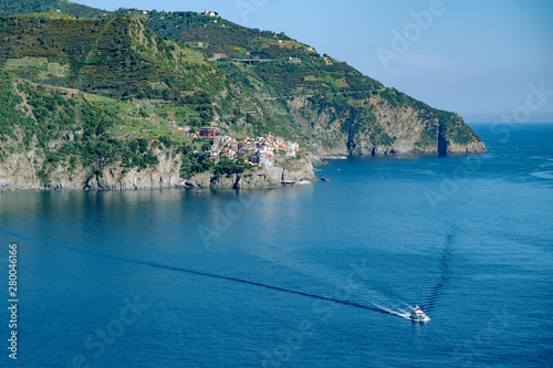 Sea rock coast, view from Corniglia, Italy. Blue water wave at Cinque Terre, Liguria