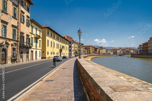 Cityscape view of Arno River in Pisa city old town in a sunny day, Italy