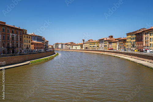 Cityscape view of Arno River in Pisa city old town in a sunny day, Italy