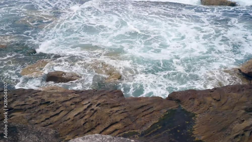 Waves crashing into a rocky shoreline on a wintery day Waves crashing into a rocky shoreline on a wintery day