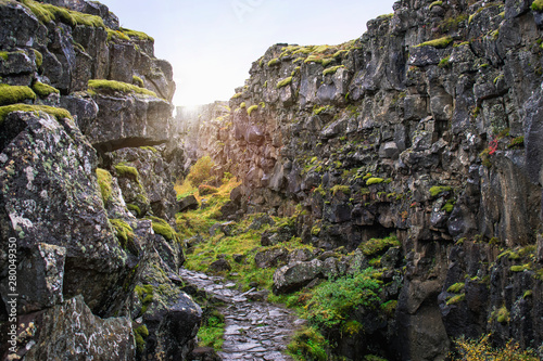 Picturesque rugged rift valley trail in Thingvellir National Park, South Iceland. Place where Eurasian and North American tectonic plates move apart. Golden circle route. 