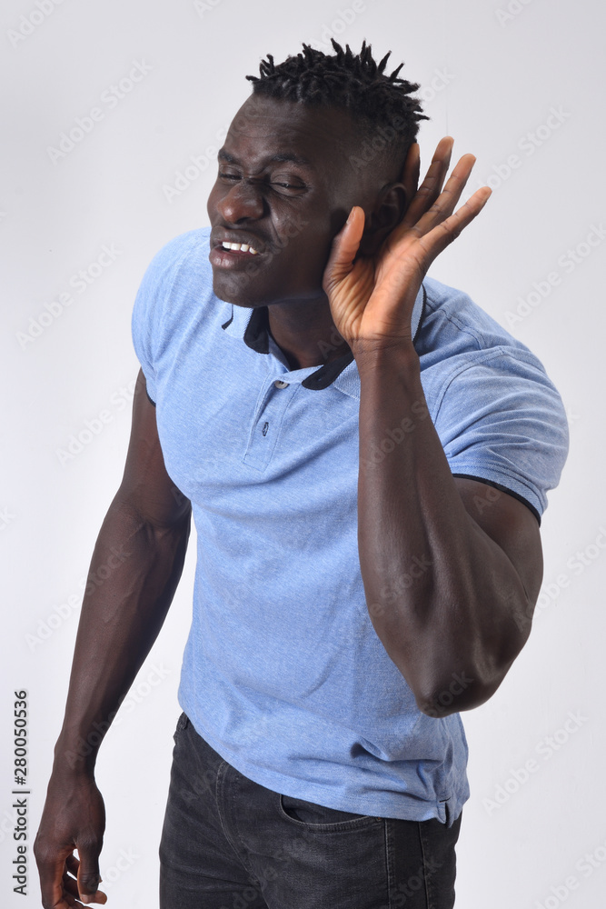 african man putting a hand on her ear because she can not hear on white background african man putting a hand on her ear because she can not hear on white background