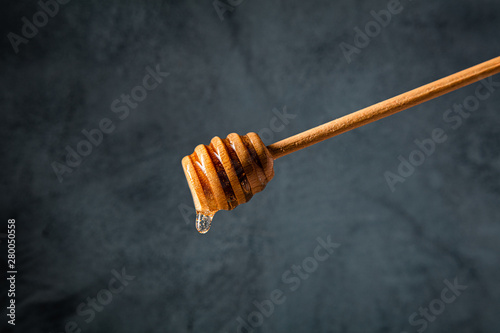 wooden stick for honey with honey