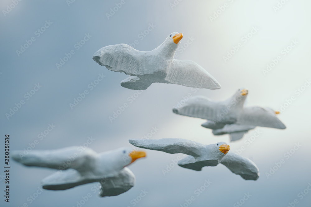 white concrete model bird with cloudy sky and sun light background white concrete model bird with cloudy sky and sun light background