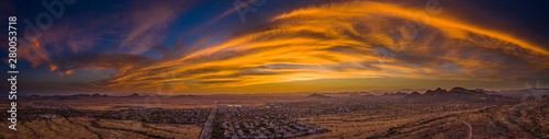 Panoramic aerial view of a desert community in Arizona during the golden hour at sunset.