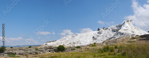 Fototapeta Naklejka Na Ścianę i Meble -  Turkey, panoramic view of travertine terraces at Pamukkale (Cotton Castle), natural site of sedimentary rock deposited by water from the hot springs, famous for carbonate mineral left by flowing water
