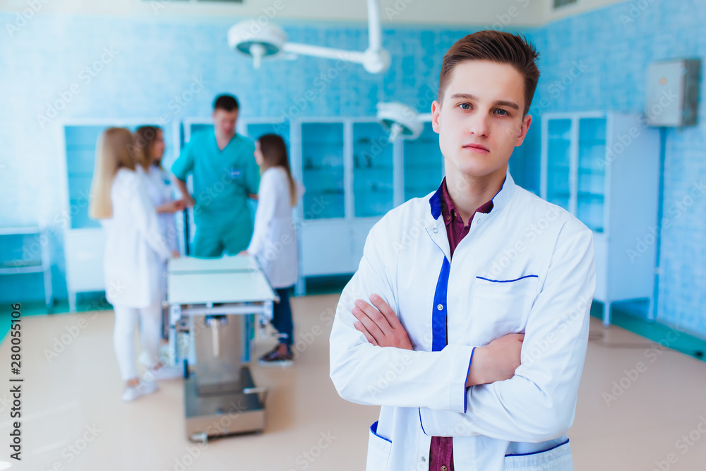 Portrait of a doctor intern. Medical students profession staff. multinational people - doctor, nurse and surgeon. A group of graduates of a medical university in a surgical room. Portrait of a doctor intern. Medical students profession staff. multinational people - doctor, nurse and surgeon. A group of graduates of a medical university in a surgical room.