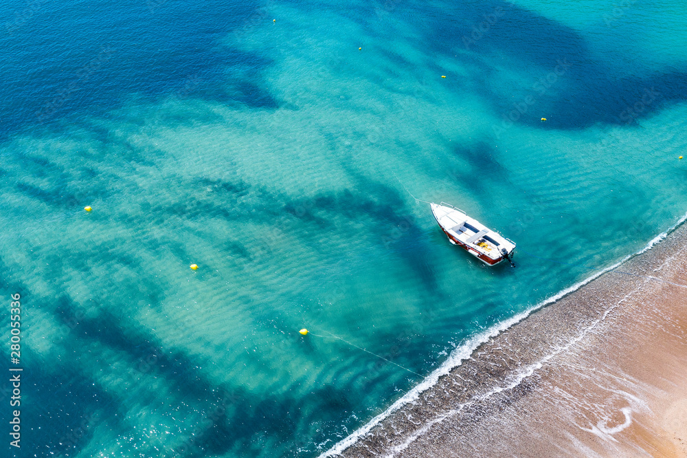 Aerial view of a boat on water and sandy coastline view