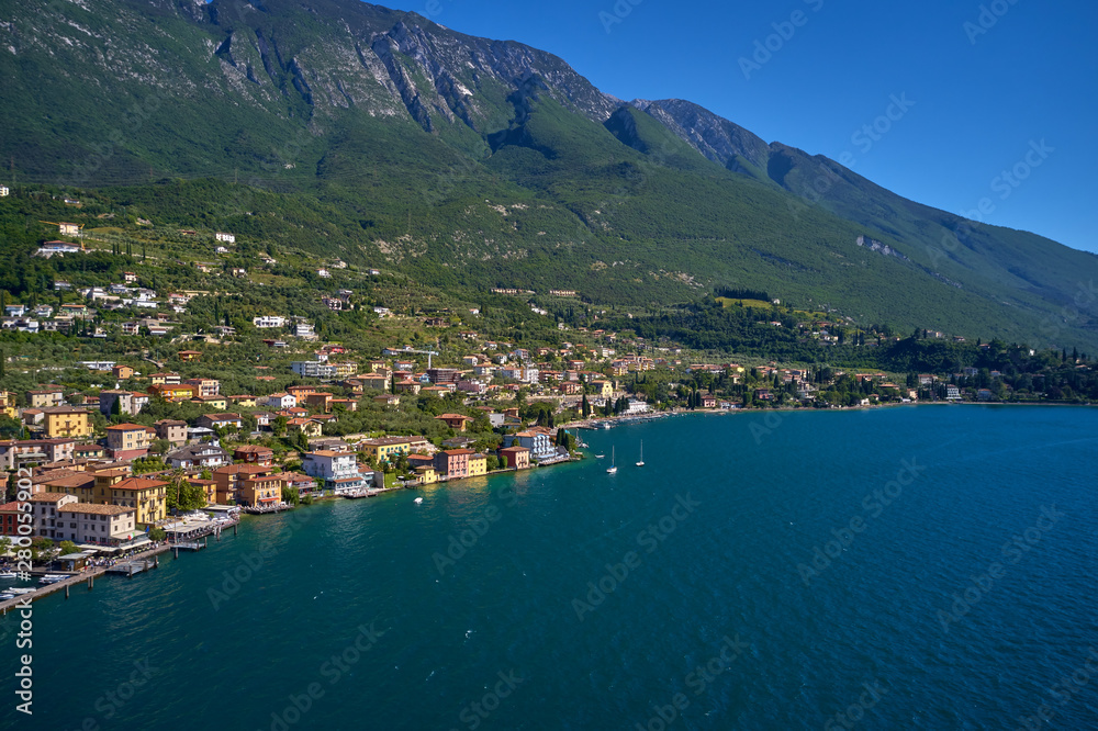 Aerial photography with drone, on the medieval lakeside castle with a museum of history and paleontology, as well as a panoramic view from the tower. City of Malcesine on Lake Garda, Italy.