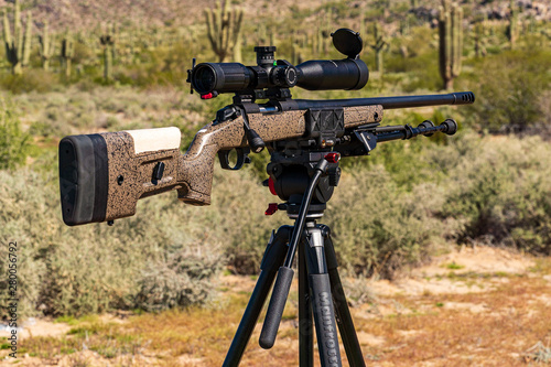 Precision Bolt-Action Rifle on shooting tripod at outdoor range
