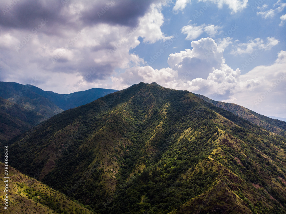 Fototapeta premium Aerial view of mountain and forest, cloudy day. Near the Ibar river and Maglic castle in Serbia