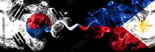 South Korea vs Philippines, Filipino smoky mystic flags placed side by side. Thick colored silky abstract smoke flags of South Korean and Philippines, Filipino
