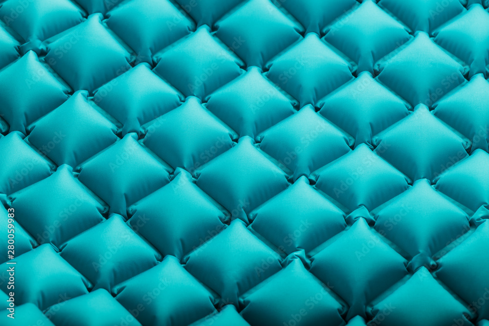 Texture of a blue inflatable tourist rug, repeating sections and patterns. Air mattress Ultralight Portable rug. Texture of a blue inflatable tourist rug, repeating sections and patterns. Air mattress Ultralight Portable rug.