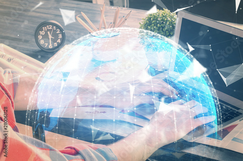 Wallpaper Mural Double exposure of businessman working on laptop on background. International business hologram in front. Concept of success. Torontodigital.ca