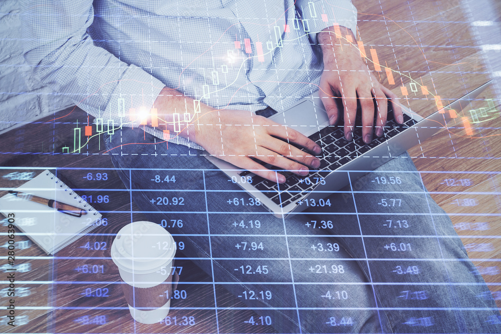 Financial forex graph drawn over hands taking notes background. Concept of research. Double exposure Financial forex graph drawn over hands taking notes background. Concept of research. Double exposure