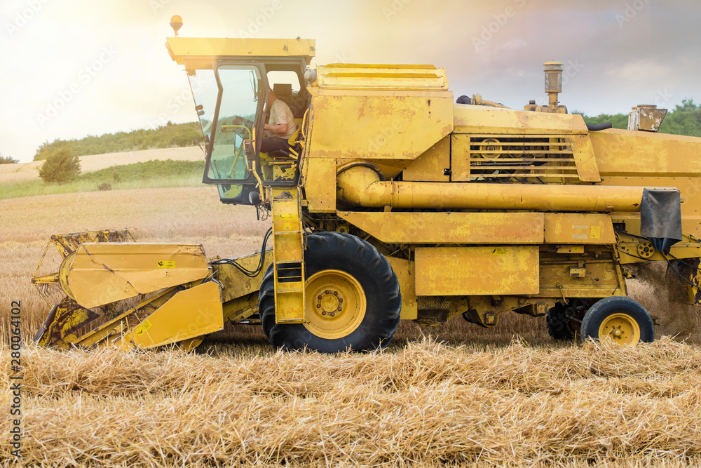 combine and a tractor during the harvest combine and a tractor during the harvest
