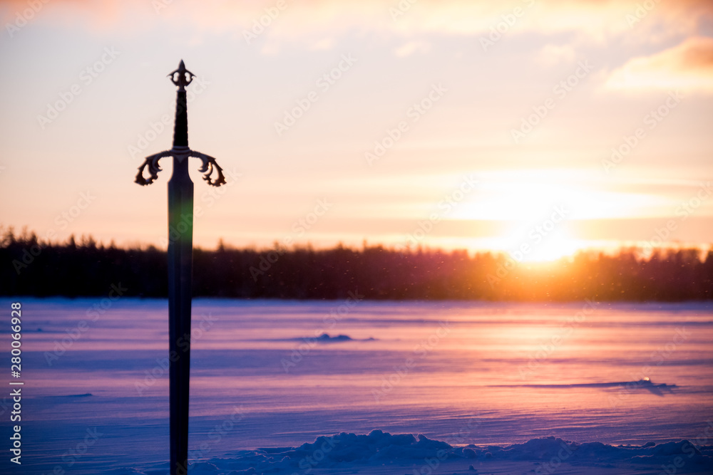 Sword in the snow at dawn