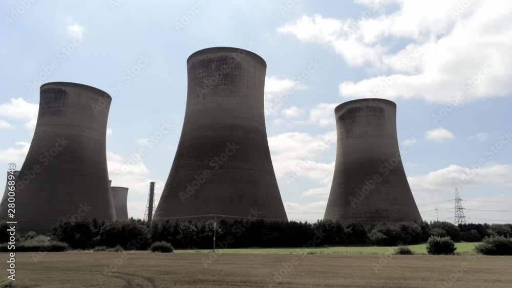 Power station cooling towers in agricultural landscape. Low aerial looking up to top of chimneys, dolly right. Power station cooling towers in agricultural landscape. Low aerial looking up to top of chimneys, dolly right.
